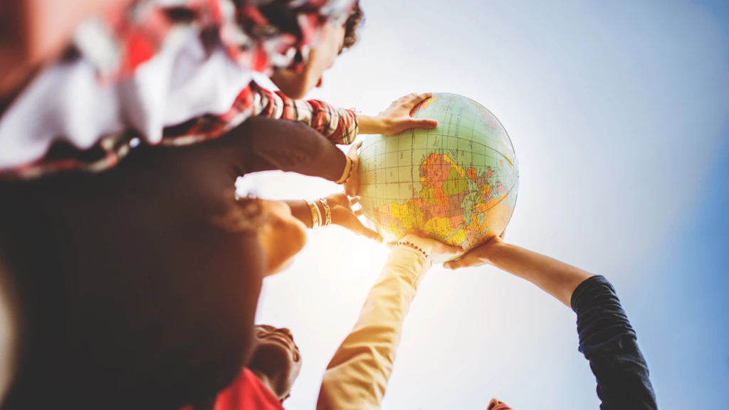 Multiple arms holding up a globe to the sky